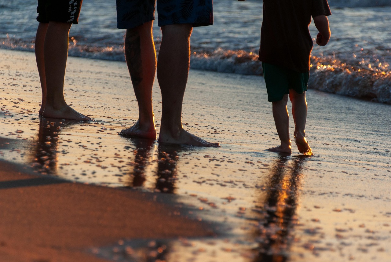 Bare feet at the edge of the surf on a Central Coast beach