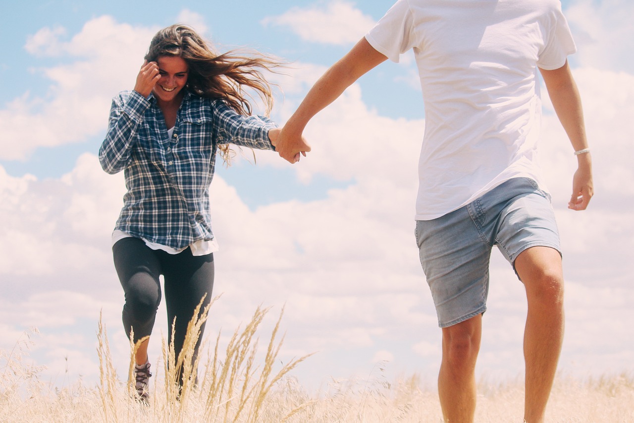 Active couple walking together outdoors under an open sky